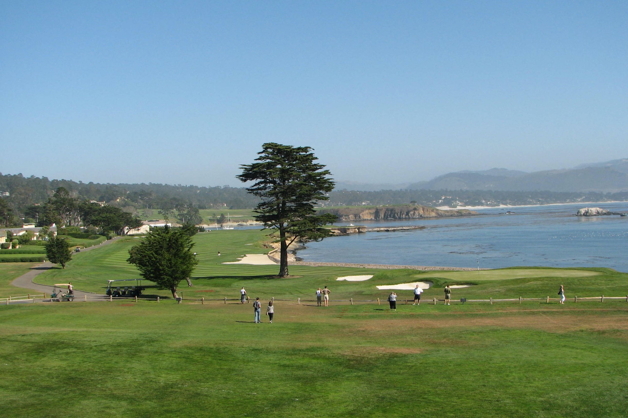 The 18th hole at Pebble Beach Golf Links, curving along the edge of Carmel Bay
